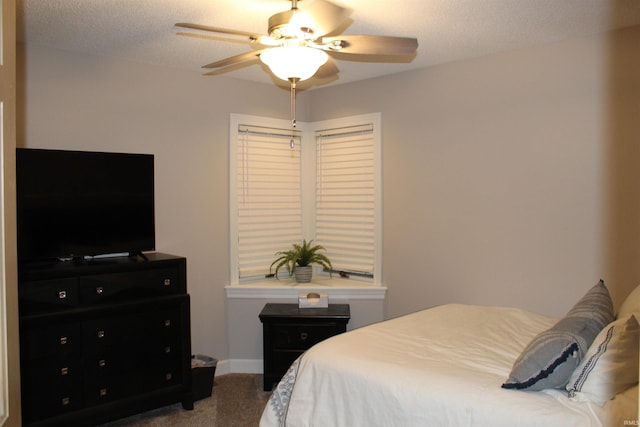 bedroom with carpet, ceiling fan, and a textured ceiling