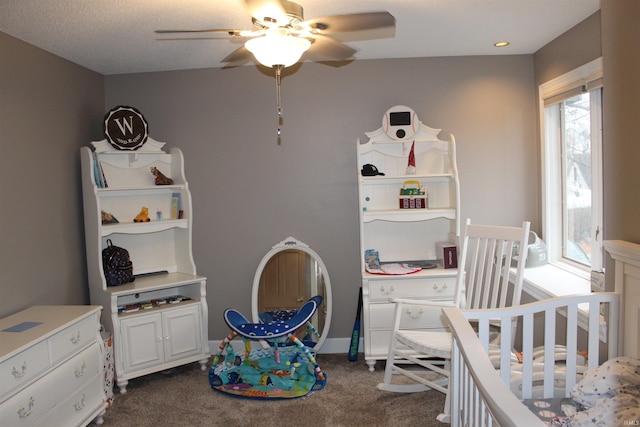 bedroom featuring ceiling fan and dark colored carpet