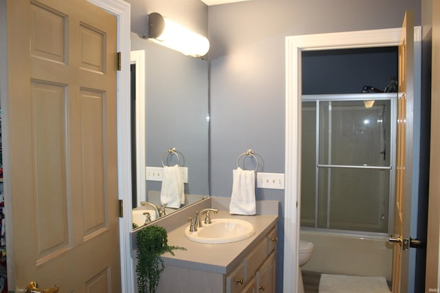 full bathroom featuring vanity, toilet, and enclosed tub / shower combo