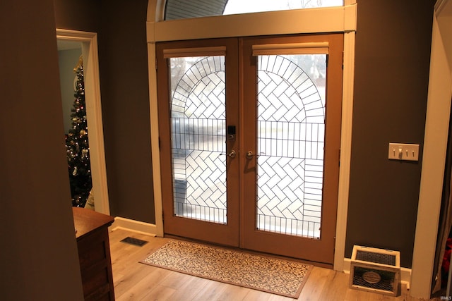 entrance foyer with light hardwood / wood-style flooring and french doors