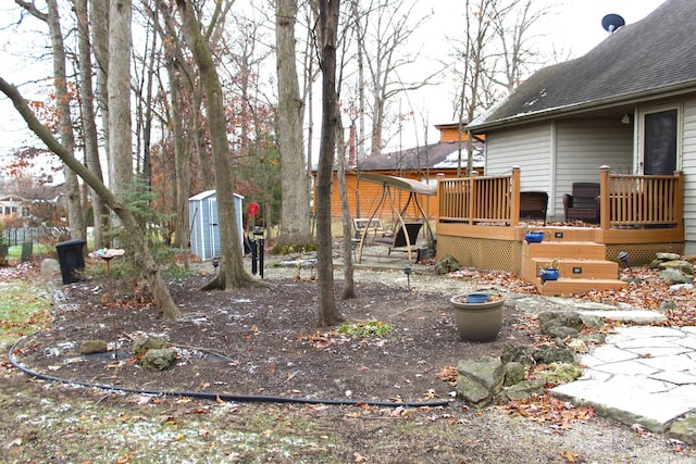 view of yard featuring a storage shed and a deck