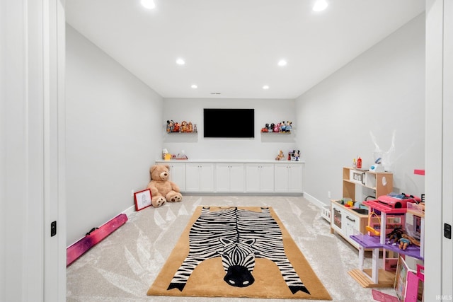 rec room featuring light carpet