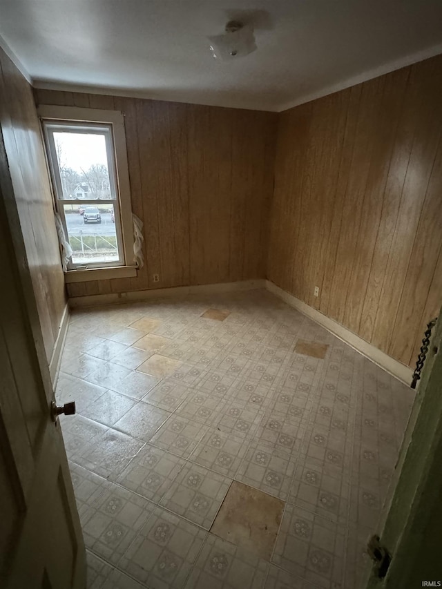 empty room featuring wooden walls