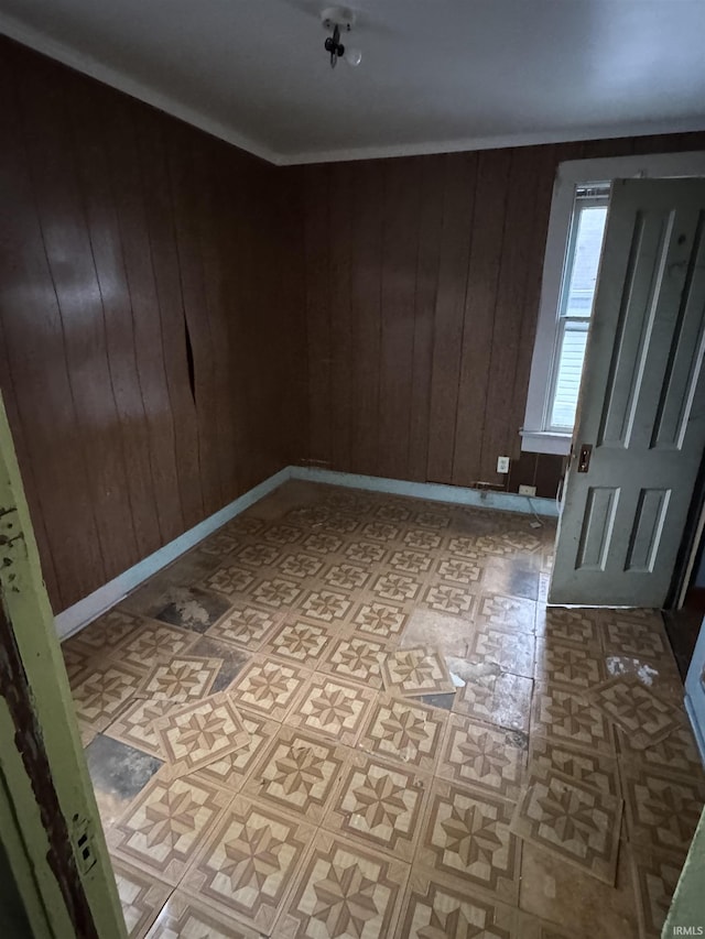 empty room featuring wood walls