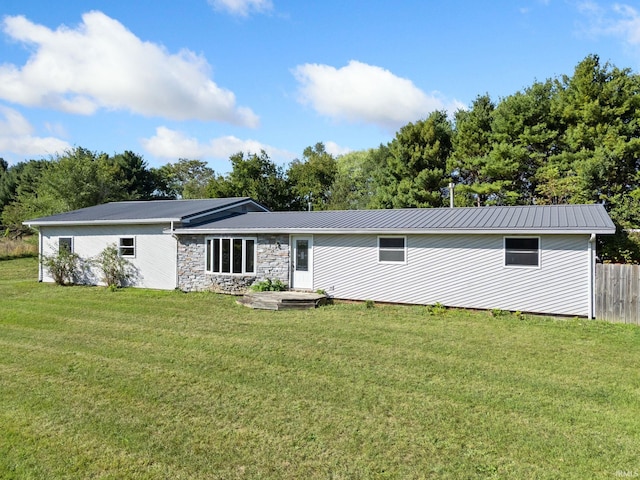 rear view of house with a yard