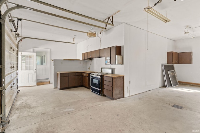 kitchen featuring stove and dark brown cabinetry