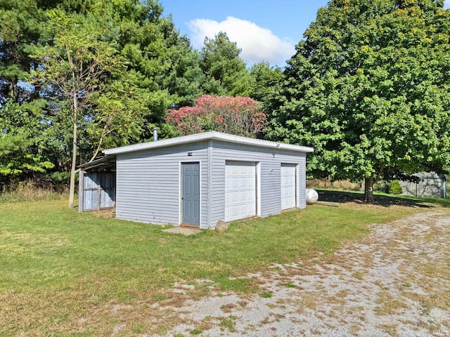 garage featuring a lawn