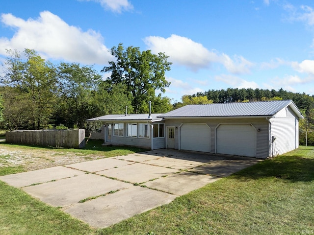 ranch-style house featuring a garage and a front lawn