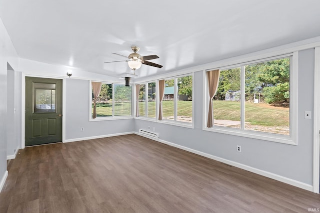 unfurnished sunroom with ceiling fan and a baseboard radiator