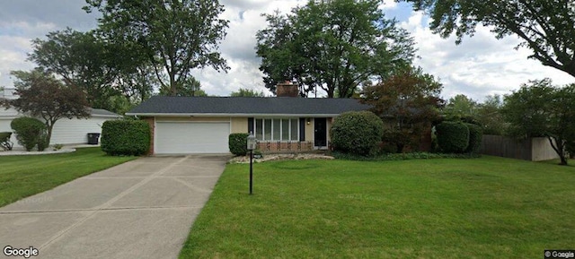 ranch-style house featuring a front lawn and a garage