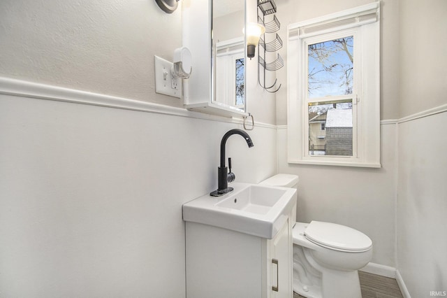 bathroom with vanity, toilet, and baseboards