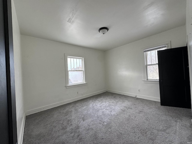 carpeted spare room featuring a healthy amount of sunlight