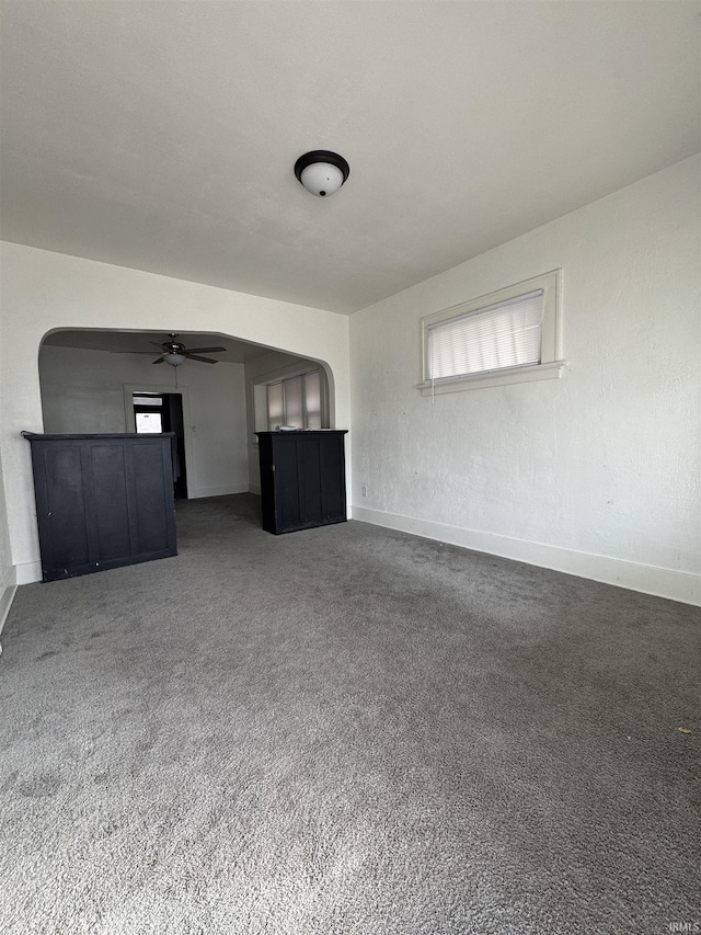 unfurnished living room featuring ceiling fan, carpet floors, and a healthy amount of sunlight