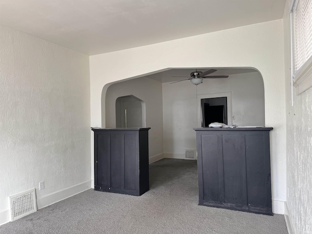 spare room with ceiling fan and carpet