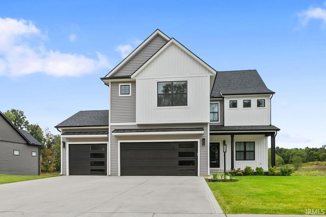 view of front of property with a garage and a front yard