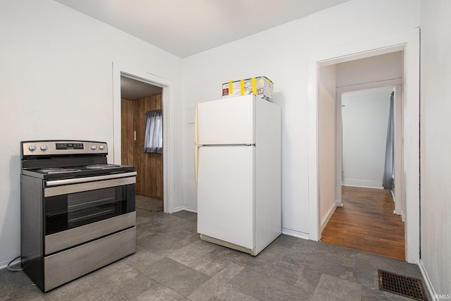 kitchen with stainless steel electric range oven and white refrigerator