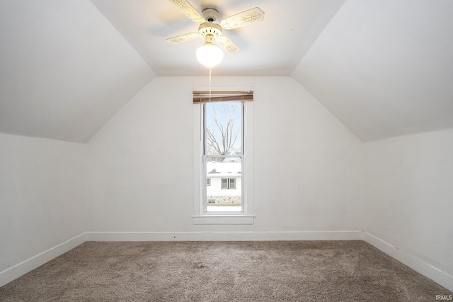 additional living space with carpet flooring, ceiling fan, and vaulted ceiling