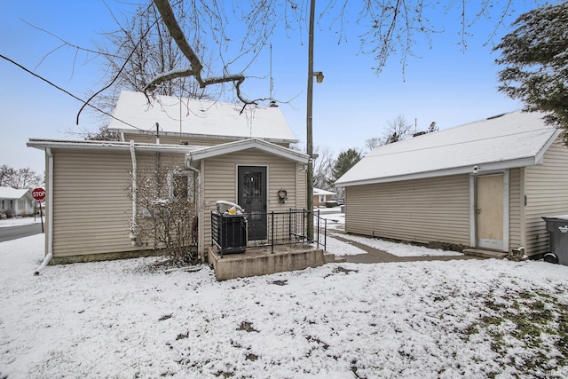 view of snow covered back of property