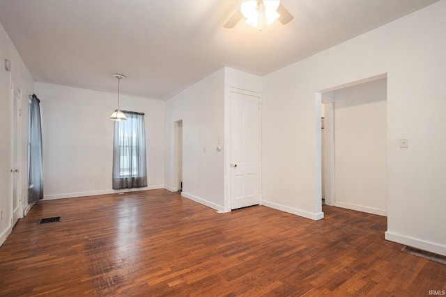 empty room featuring ceiling fan and dark hardwood / wood-style flooring