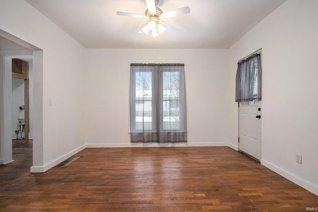 spare room featuring ceiling fan and dark wood-type flooring