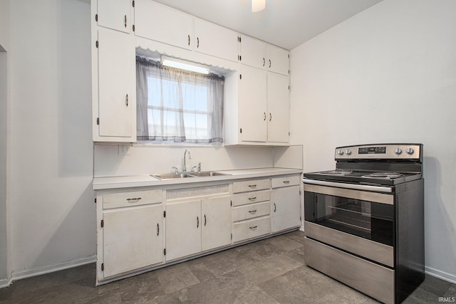 kitchen with sink, white cabinetry, and stainless steel range with electric cooktop