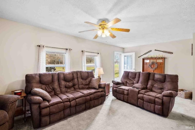 living room with ceiling fan, carpet, and a textured ceiling