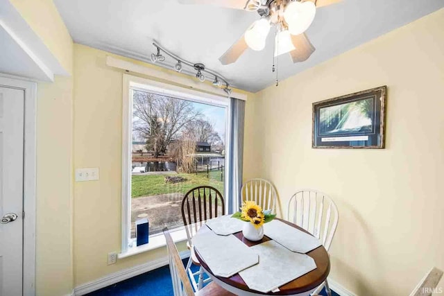 dining space with track lighting and ceiling fan