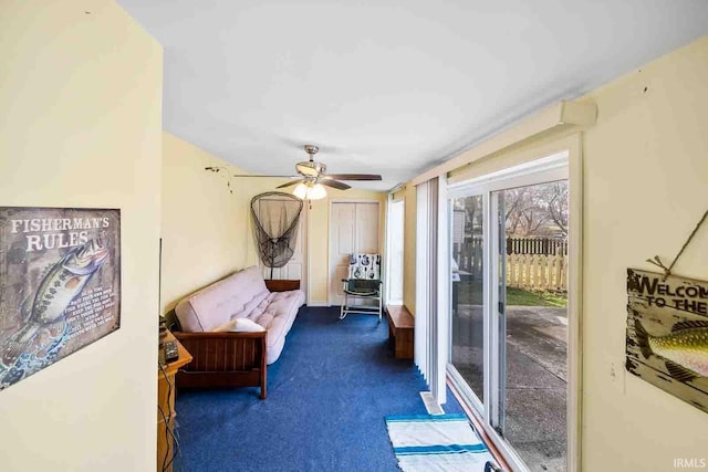 interior space featuring ceiling fan and dark colored carpet