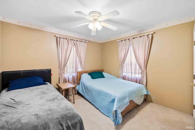 carpeted bedroom with ceiling fan