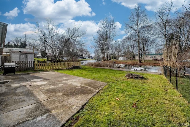 view of yard with a patio area and a water view