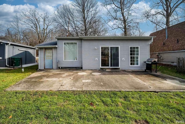 back of property featuring a yard and a patio area