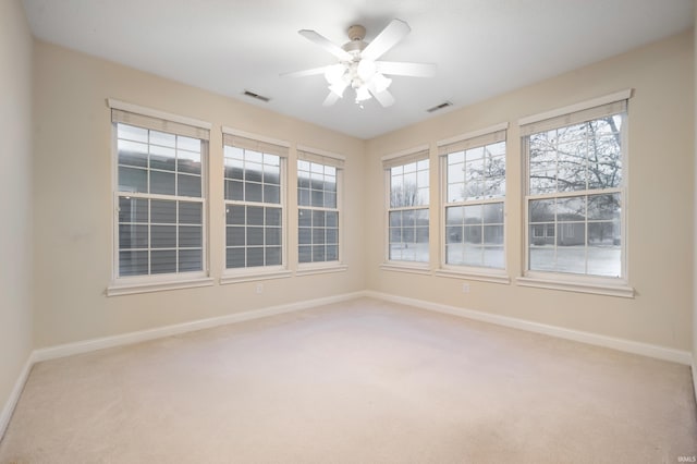 carpeted spare room with ceiling fan