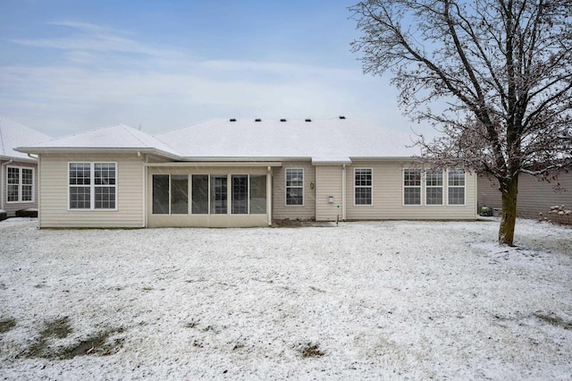 snow covered property with a sunroom