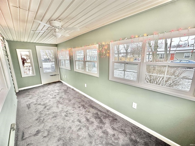 unfurnished sunroom featuring ceiling fan, lofted ceiling, and wood ceiling