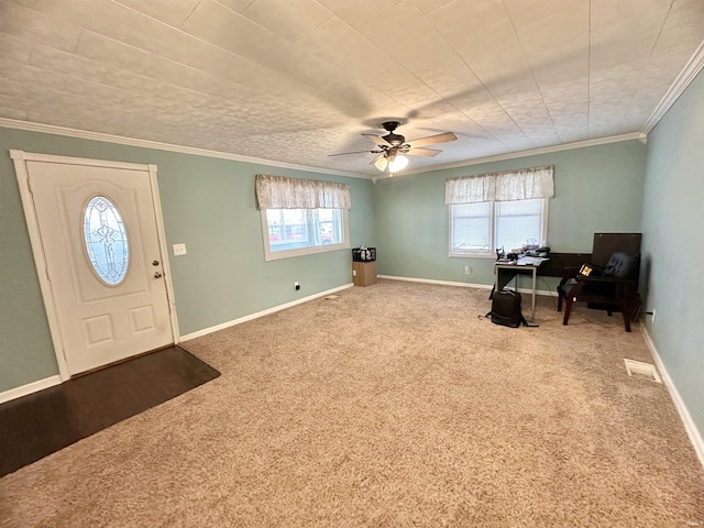 entrance foyer with carpet, ceiling fan, plenty of natural light, and ornamental molding