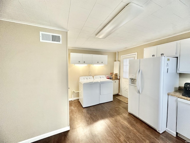 clothes washing area featuring separate washer and dryer, dark hardwood / wood-style floors, and ornamental molding