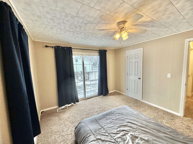 bedroom featuring ceiling fan and carpet