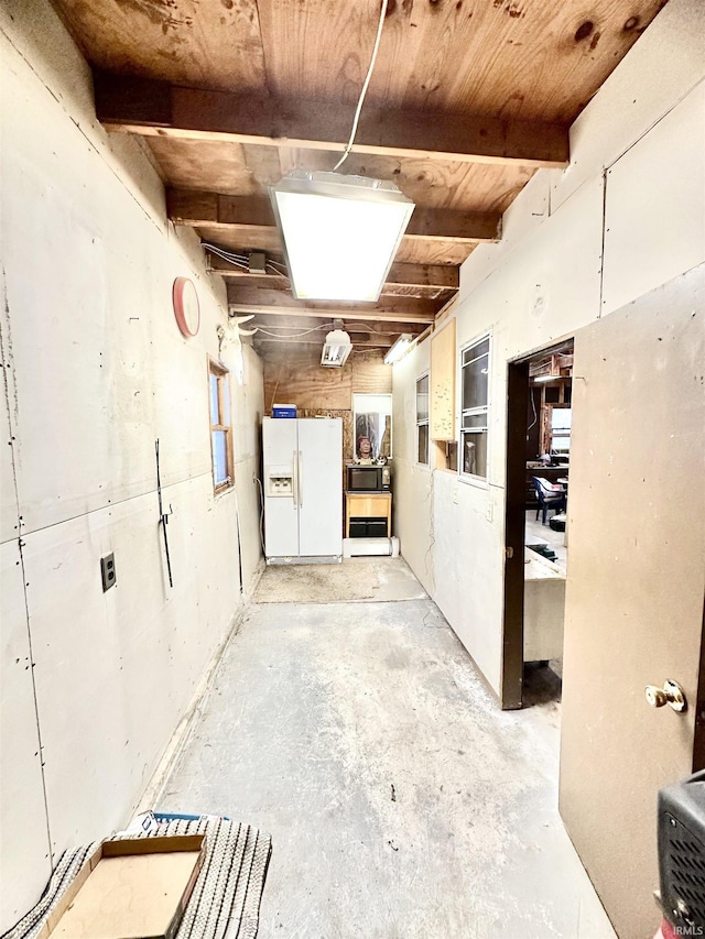 interior space featuring white refrigerator with ice dispenser and wood ceiling