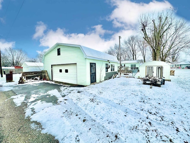 exterior space featuring a garage and a shed