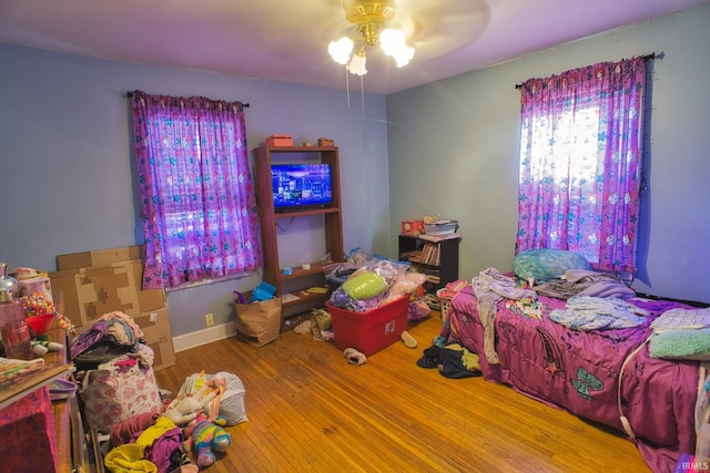 bedroom with hardwood / wood-style floors and ceiling fan