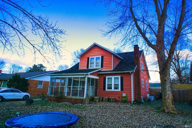 view of front of home featuring a sunroom