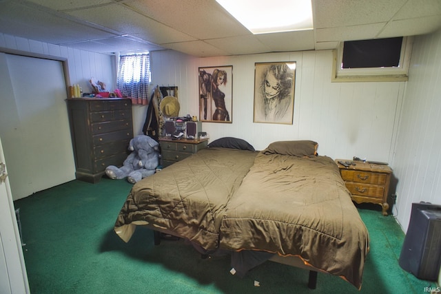 carpeted bedroom with a paneled ceiling