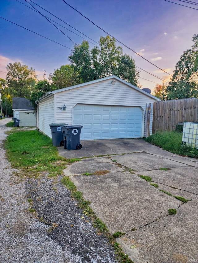 view of garage at dusk