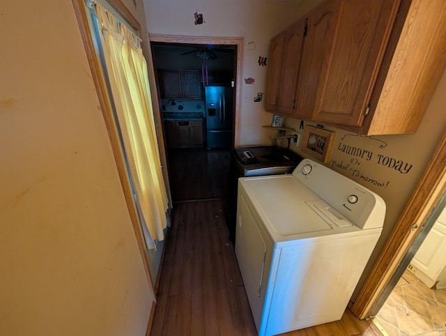 laundry room featuring cabinets, separate washer and dryer, and light hardwood / wood-style flooring