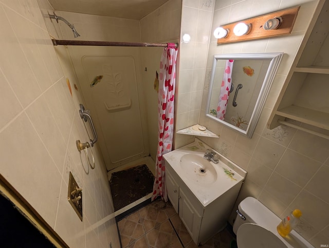 bathroom featuring vanity, tile patterned flooring, toilet, tile walls, and walk in shower