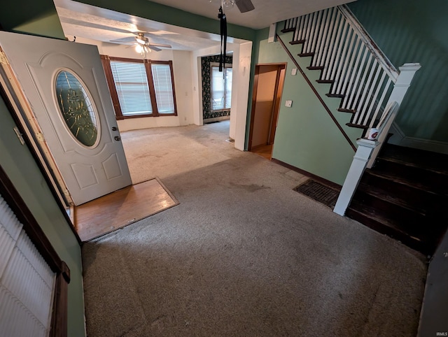 carpeted foyer entrance featuring ceiling fan