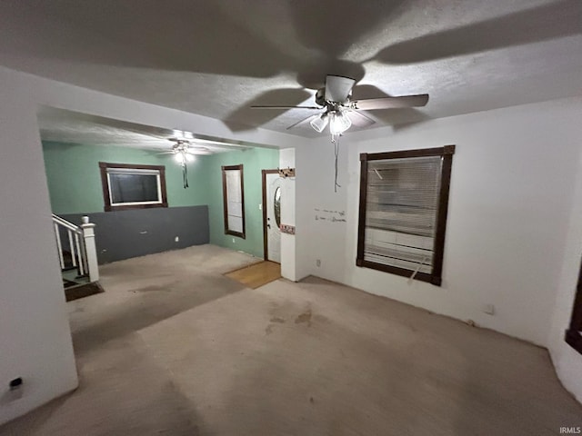 unfurnished living room featuring ceiling fan