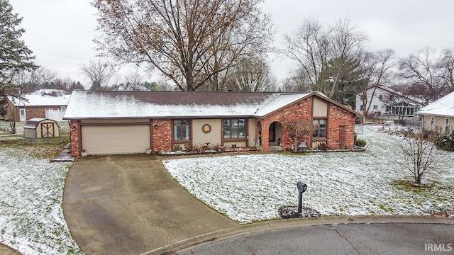 view of front of home featuring a garage and a storage shed