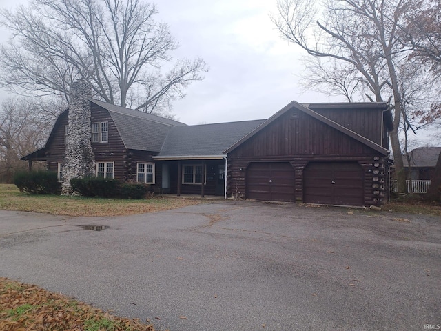 log-style house with a garage