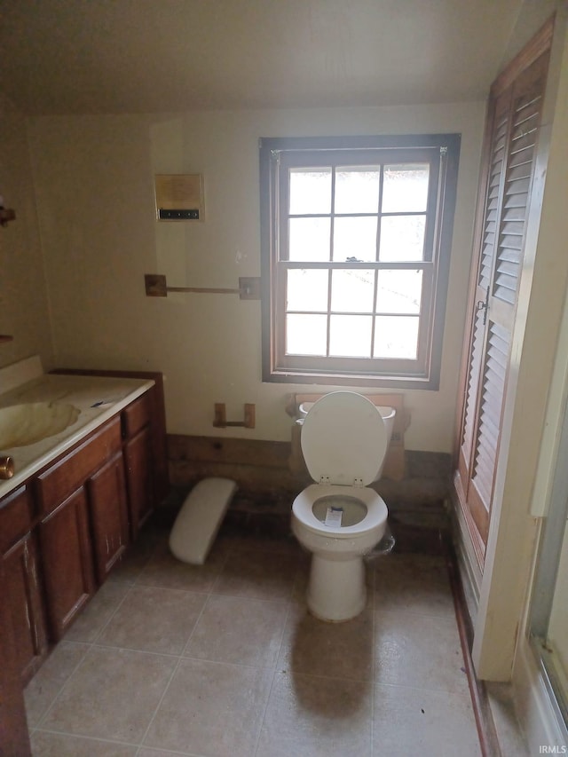 bathroom with tile patterned flooring, vanity, and toilet